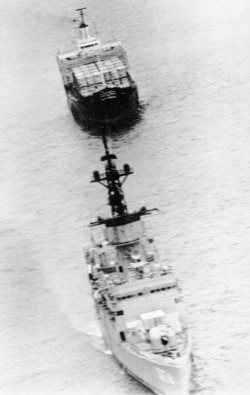 The U.S. merchant ship SS Mayaguez, rear, is towed away from Koh Tang island by the destroyer USS Harold E. Holt, May 15, 1975, after American military forces freed her from Cambodian captivity. (AP Photo)