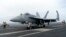 A F-18E parks on the flight deck of a USS Theodore Roosevelt aircraft carrier on Thursday, April 11, 2024 during a three-day joint naval exercise by the U.S., Japanese and South Korea at the East China Sea.