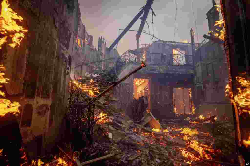 The Palisades Fire burns a residence in the Pacific Palisades neighborhood of Los Angeles, Jan. 7, 2025.