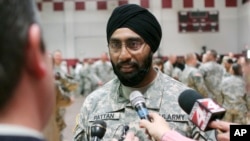 FILE - U.S. Army Capt. Tejdeep Singh Rattan speaks to journalists at a U.S. Army officer basic training graduation ceremony at Fort Sam Houston in San Antonio, March 22, 2010. Rattan was the first Sikh allowed to complete officer basic training while wearing the traditional turban and full beard since the Army altered the dress code, which had made exceptions for Sikh soldiers, in 1984.