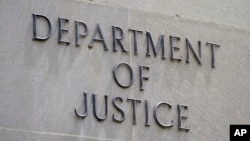 FILE - The outside of the Department of Justice building in Washington. The justice department says Mohammad Sharifullah has been charged with 'providing and conspiring to provide material support and resources to a designated foreign terrorist organization resulting in death.'