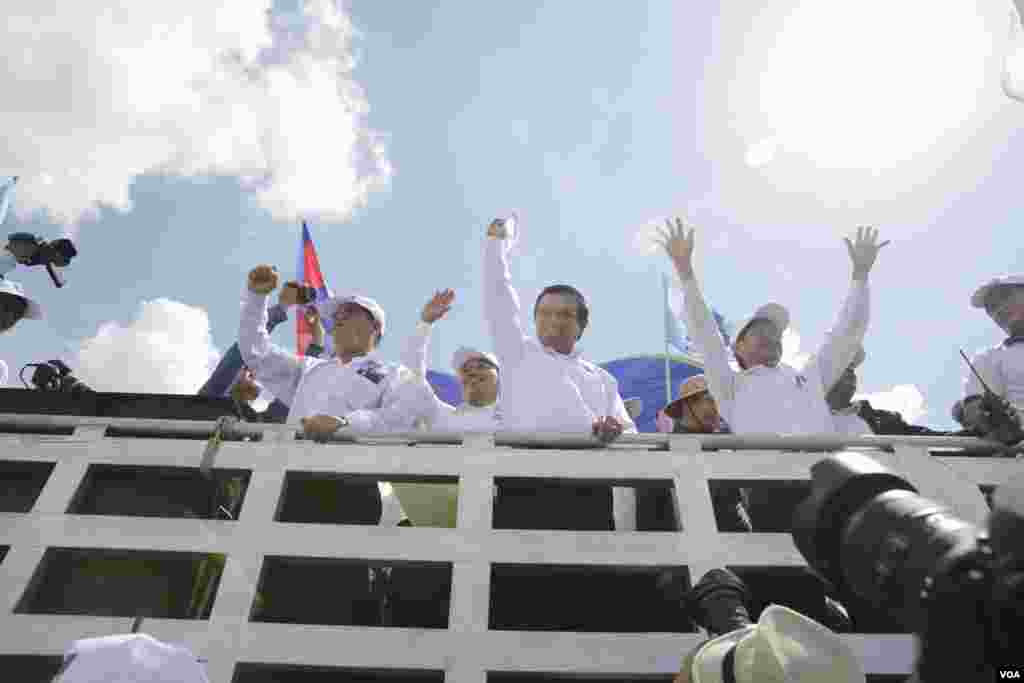 លោក កឹម សុខា មេដឹកនាំគណបក្សសង្រ្គោះជាតិលើកដៃទៅកាន់អ្នកគាំទ្រក្នុងការដង្ហែក្បួនឃោសនាបោះឆ្នោតថ្ងៃចុងក្រោយ កាលពីព្រឹកថ្ងៃទី០២ ខែមិថុនា ២០១៧។ (ខាន់ សុគុំមនោ/VOA)