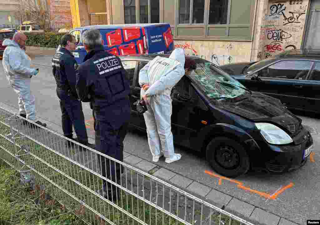 Forensic experts work on a car which drove into a crowd, in Mannheim. A car drove into a crowd in the western German city, killing at least two people and seriously injuring several others, overshadowing carnival celebrations in the region where police had been on alert for attacks. 