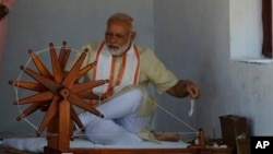 Perdana Menteri India Narendra Modi mencoba tangannya di roda berputar saat berkunjung ke Gandhi Ashram, kediaman Mahatma Gandhi, di Ahmadabad, India, 29 Juni 2017.