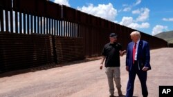 FILE - Republican presidential nominee former President Donald Trump listens to Paul Perez, president of the National Border Patrol Council, as he tours the southern border with Mexico, on Aug. 22, 2024, in Sierra Vista, Ariz. 