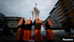 Nuns gather near a makeshift memorial outside Gemelli Hospital in Rome, where Pope Francis is being treated for double pneumonia, March 8, 2025. 