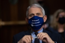 FILE - Dr. Anthony Fauci, Director of the National Institute of Allergy and Infectious Diseases, listens during a hearing on Capitol Hill, Sept. 23, 2020.