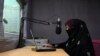 FILE - In this photo taken on Sept. 29, 2020, radio presenter Shukria Wali reads the news during a broadcast at the Merman radio station in Kandahar.