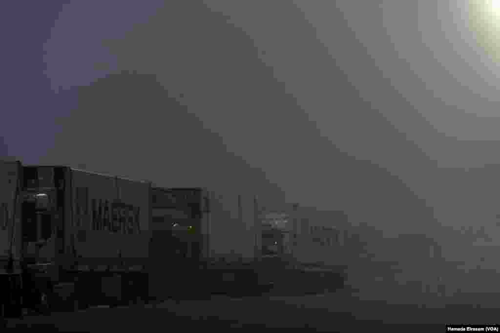 Trucks carrying vital humanitarian aid line up on the main road to the Rafah crossing amid harsh weather conditions. On the other side of the border, officials say as many as 14,000 Palestinians, including 2,500 children, require urgent medical evacuation. Rafah, Egypt, Feb. 4, 2025.