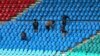 Workers clean pavilion seats on the eve of the International Cricket Council Champions Trophy match between Pakistan and New Zealand at National Stadium in Karachi on Feb. 18, 2025.