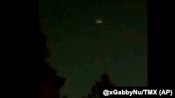 In this image taken from video, what appears to be a drone is seen above treetops in Flanders, New Jersey, Dec. 3, 2024.