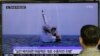 FILE - A South Korean man watches a TV news program showing an image published in North Korea's Rodong Sinmun newspaper of North Korea's ballistic missile believed to have been launched from underwater, at Seoul Railway station in Seoul, South Korea.