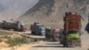FILE - Trucks carrying Afghan families move toward a border crossing at Torkham, Pakistan, Oct. 31, 2023. Pakistan launched a repatriation program in October 2023 after a spike in violence that Islamabad blamed on militants operating from Afghanistan.