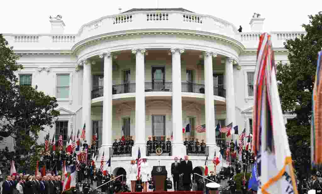 President Donald Trump, French President Emmanuel Macron, first lady Melania Trump and Brigitte Macron, stand during a State Arrival Ceremony on the South Lawn of the White House in Washington, April 24, 2018.