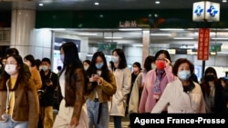Commuters exit a Mass Rapid Transport (MRT) station in Xindian in New Taipei City on Jan. 3, 2022, after a strong earthquake struck off the coast of eastern Taiwan with shaking felt in the capital Taipei.