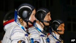 Dari kiri: astronot NASA Kathleen Rubins, kosmonot Rusia Anatoly Ivanshin dan astronot Jepang Takuya Onishi sebelum diluncurkan dari kompleks antariksa Rusia di Baikonur, Kazakhstan, hari Kamis (7/7).
