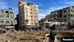 Warga Palestina memeriksa kerusakan yang timbul akibat serangan Israel pada Rumah Sakit Kamal Adwan di utara Jalur Gaza, pada 16 Desember 2023. (Foto: Reuters/Fadi Alwhidifa)