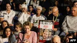 Relatives, friends and supporters of Elkana Bohbot, who has been held hostage in Gaza since the October 7 attack by Hamas militants in southern Israel, take part in a protest to ask for the release of Israeli hostages, in Tel Aviv on Nov. 22, 2023.