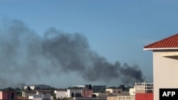 A plume of smoke rises in Bamako as shots and detonations are heard, in this image taken from an AFPTV video on Sept. 17, 2024. Unidentified gunmen attacked at least one police base in the Malian capital of Bamako on the morning of September 17, a police source said.