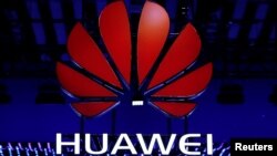 FILE - The Huawei logo is seen during the Mobile World Congress in Barcelona, Spain, Feb. 26, 2018.
