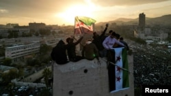 FILE - People celebrate in Umayyad Square on Dec. 20, 2024, after the ousting of Syria's Bashar al-Assad. Syria's new rulers have appointed Murhaf Abu Qasr as defense minister in the interim government, a source said on Saturday.