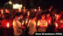 Families of trafficking victims and human rights activists have held demonstrations, including this candlelight vigil in Malaysia.