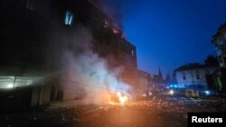 FILE - A residential building and cars burn following Russian missile and drone strikes in Lviv, Ukraine, Sept. 4, 2024.