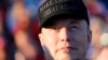 FILE - Tesla and SpaceX CEO Elon Musk listens as Republican presidential nominee former President Donald Trump speaks at a campaign event at the Butler Farm Show, Oct. 5, 2024, in Butler, Pa.