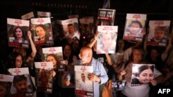 Demonstranti drže fotografije talaca koje je oteo Hamas, na protestu u Tel Avivu 21. oktobra (AFP)