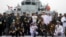 FILE - Foreign naval officers gather for a photo on the naval training ship Qi Jiguang before a parade to commemorate the 70th anniversary of the founding of China's PLA Navy April 23, 2019.