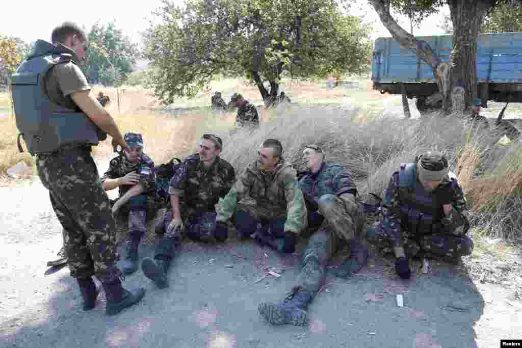 Soldiers of the Ukrainian self-defence battalion "Azov" rest at a checkpoint in the southern coastal town of Mariupol, Sept. 5, 2014.