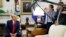 FILE - President Donald Trump talks to reporters in the Oval Office of the White House, in Washington, July 9, 2019.