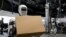FILE - A view of Apollo, the humanoid robot built by Apptronik, Inc. carries a package at Austin, Texas, October 25, 2023.