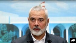 FILE - In this photo released by Lebanese government, Ismail Haniyeh, the leader of Hamas, speaks during a press conference in Lebanon, June 28, 2021. Hamas said Haniyeh is in Cairo to discuss the war in Gaza.