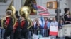 Viewers at the Columbus Day Parade wave a U.S. flag with Italian national colors and signs of expression, Oct. 14, 2019, in New York. 