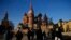 FILE - People walk on the Red Square next to St. Basil's Cathedral and the Spasskaya tower of the Kremlin on a sunny day in Moscow, Nov. 26, 2024. 