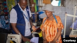 Adelle Mubalama, right, a tailor with a shop at Kenya's Kakuma refugee camp, was able to launch a business when she got a loan from Inkomoko. The organization helps small business entrepreneurs. (Photo courtesy of Inkomoko)