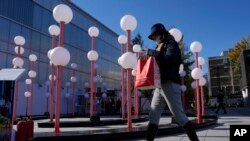 2023年11月11日,周六,一名购物者走过北京的一个购物中心。(美联社)