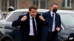 FILE - French President Emmanuel Macron gets ready to attend a function in Lievin, northern France, Feb. 2, 2022. Macron heads to Moscow this week for talks with Russian President Vladimir Putin.