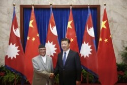 Chinese President Xi Jinping (R) shakes hands with Nepal Prime Minister Khadga Prasad Sharma Oli (L) inside the Great Hall of the People in Beijing on March 21, 2016. (Lintao Zhang/Reuters)