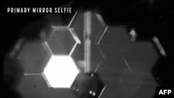 In this undated image obtained from NASA on Feb. 11, 2022, the Webb Space Telescope takes a selfie, using a specialized lens inside an instrument that was designed to take images of the primary mirror segments instead of images of space.