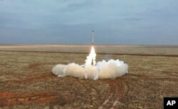 This photo taken from video provided by the Russian Defense Ministry Press Service on Feb. 19, 2022, shows a Russian Iskander-K missile launched during a military exercise at a training ground in Russia.