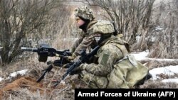 Ukrainian soldiers take part in exercises in an unknown location, Feb. 18, 2022
