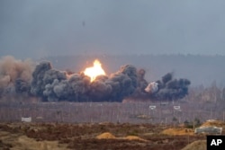 Smoke and flames rise over a field during the "Union Courage-2022" Russia-Belarus military drills at the Obuz-Lesnovsky training ground in Belarus, Feb. 19, 2022.