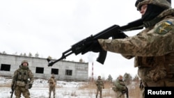 FILE - Reservists of the Ukrainian Territorial Defense Forces take part in military exercises on the outskirts of Kyiv, Jan. 29, 2022. 