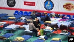 Displaced civilians from the Donetsk and Luhansk regions rest in a sport hall in Taganrog, Russia, Feb. 21, 2022.