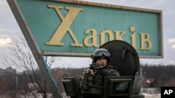 A Ukrainian National guard soldier guards the mobile checkpoint together with the Ukrainian Security Service agents and police officers during a joint operation in Kharkiv, Ukraine, Feb. 17, 2022.