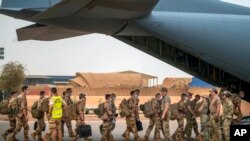 FILE - French Barkhane force soldiers who wrapped up a tour of duty in the Sahel leave their base on a transport plane in Gao, Mali, June 9, 2021.