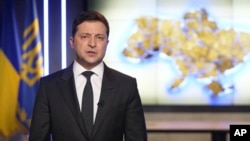 In this handout photo provided by the Ukrainian Presidential Press Office, Ukrainian President Volodymyr Zelenskyy addresses the nation.