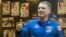 FILE - American astronaut Terry Virts, a member of the International Space Station crew, gives a thumbs up during a news conference behind a glass wall at Baikonur cosmodrome, Nov. 22, 2014. 